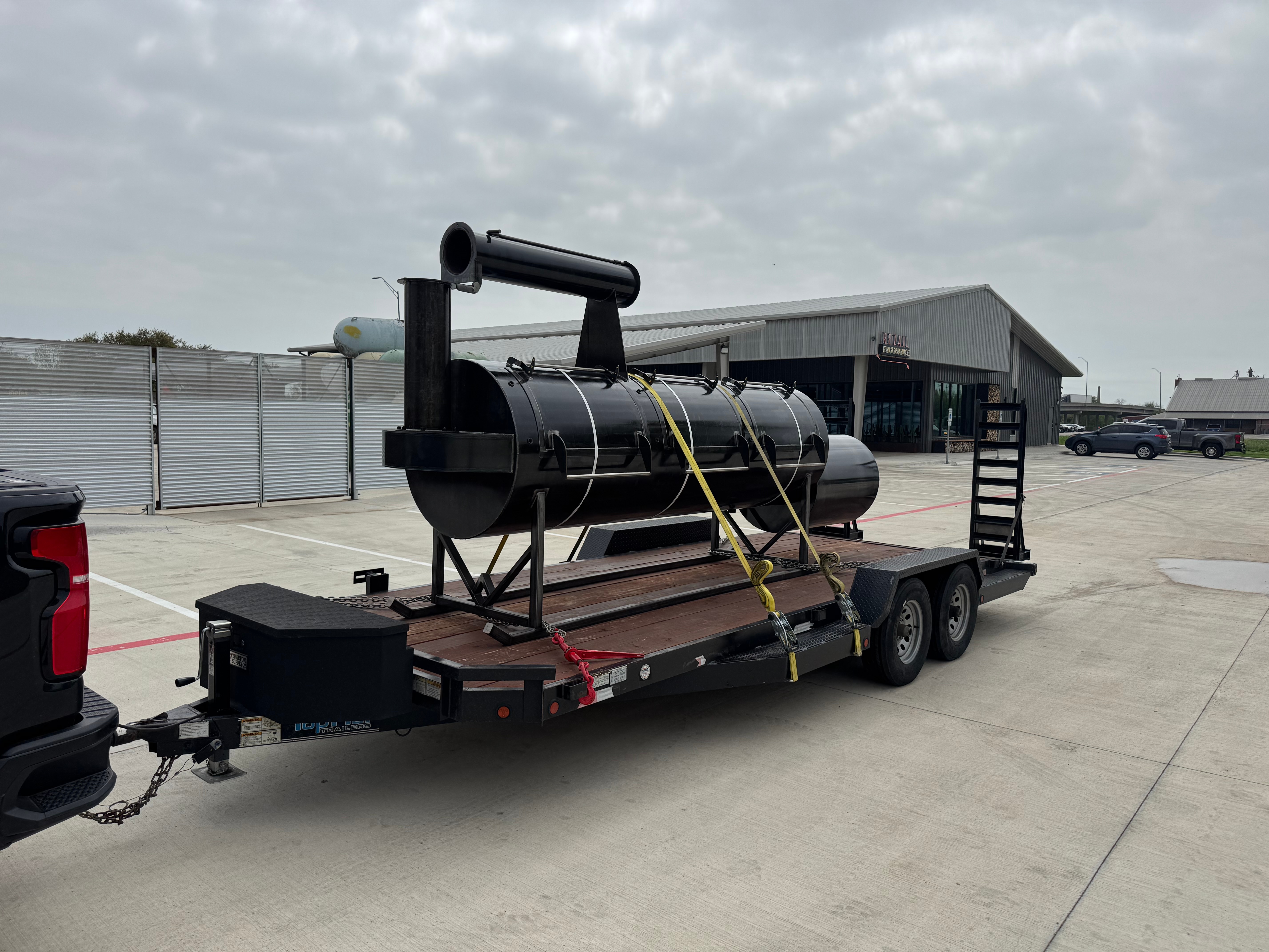 Car hauler flatbed trailer loaded with equipment in Royse City TX - Lonestar Trailer Rentals